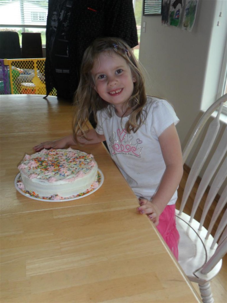 Happy birthday!  She designed that cake - white cake, mint chips, white frosting, pink decorative frosting, sprinkles and two colors of candles.  