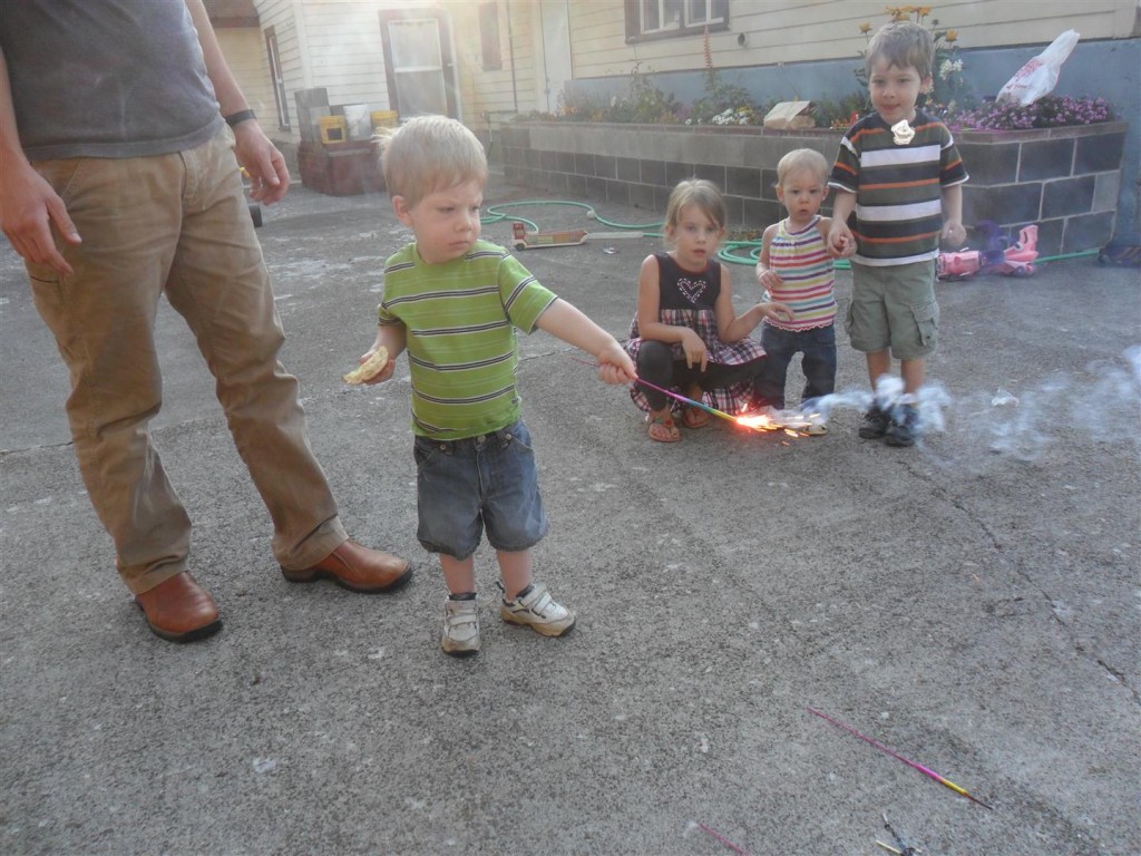 Hudson with his first sparkler made us all chuckle.  He held that elbow locked out and kept it as far away from him as possible.
