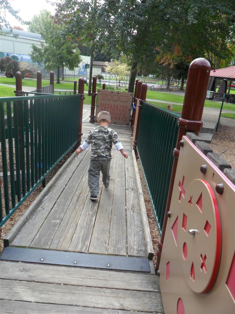 Jordan walking up and down on a play structure.  Playgrounds are kinda stressful for him.