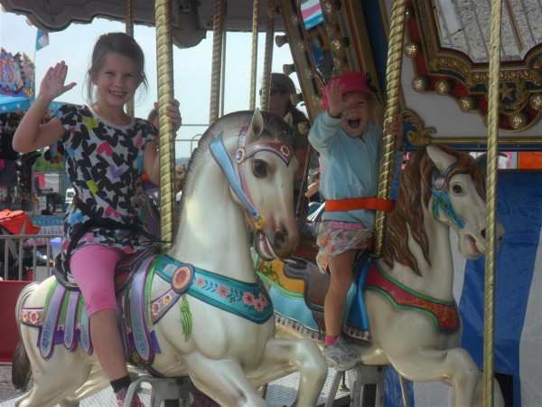 Definitely never too old for a merry go round!  My pretty girls.