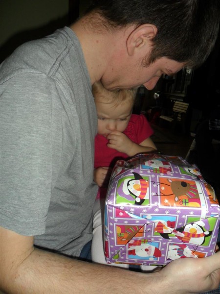 Mid gift-opening, Carolyn got sleepy and shy and snuggly and curled up in Brian's arms.