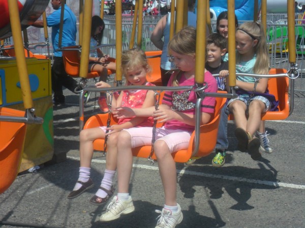 Here are Anna and Maggie getting onto a swing ride that swings them in a slow circle.