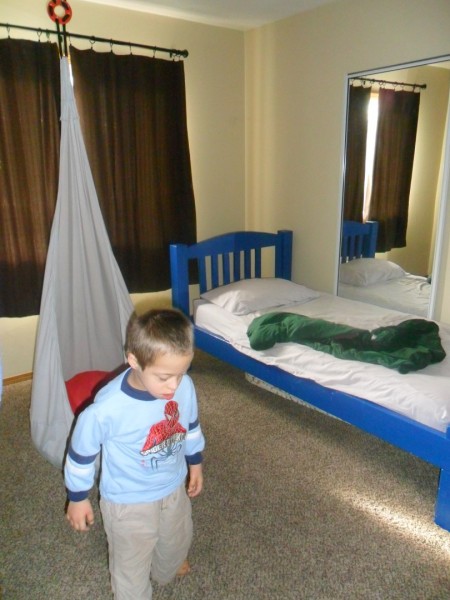 Jordan's bedroom... perfect for him. Swing (that he falls asleep in two out of three nights and we carry him to bed) his bed with a weighted blanket (that he throws on the floor anyway) and a heated mattress pad... a mirror and light-blockign windows. He has a lock on his light switch.