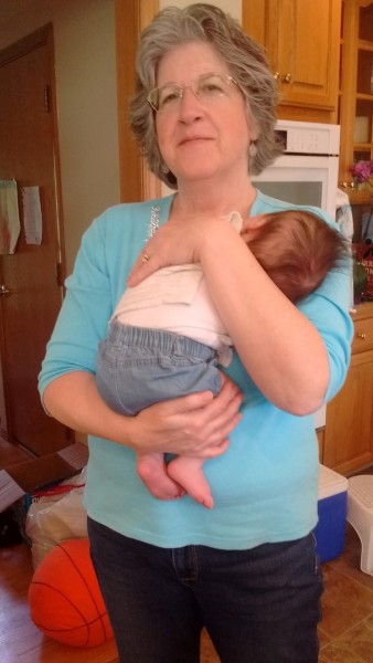 Here's my mommy holding my sister's littlest bundle.