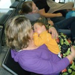 Getting love and snuggles from Grammy in the airport as they were departing for home.