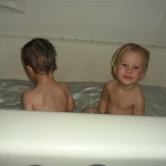 Our two-year-olds.Jordan oblivious and splashing. Maggie trying to get him to play.