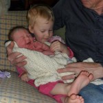 Maggie holding a newborn for the first time.