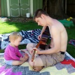 Maggie actually sat still for a little while to listen to Papa picking at his guitar in the shade this spring.
