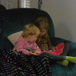 My girls mostly are great friends. Here they are watching Elmo on a little tiny video screen they got from the library.