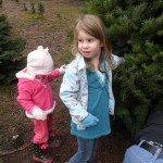 Here are the girls holding the tree we eventually chose. They were helping Papa while they cut it down.