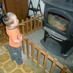 Here is Jordan NOT touching the fire or dropping things inside the fence. It was a frustrating temptation for him.